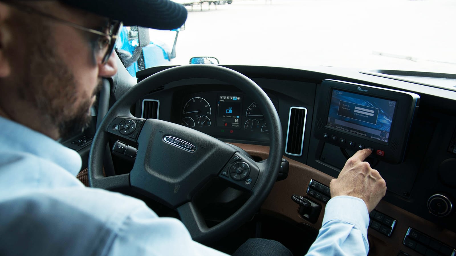 driver at the wheel of an international transportation services truck